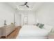 Bright bedroom features tray ceiling with fan, light wood floors, and neutral color palette at 3598 Trinity St, North Port, FL 34291