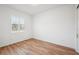 Bright bedroom featuring wood-look flooring and a window with plantation shutters at 3598 Trinity St, North Port, FL 34291
