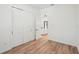 Bedroom with closet and open door to living room; features modern flooring and white walls at 3598 Trinity St, North Port, FL 34291