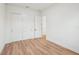 Bedroom with closet and open door to living room; features modern flooring and white walls at 3598 Trinity St, North Port, FL 34291