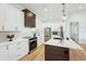Stylish kitchen with white cabinets, modern appliances, and hardwood floors at 3598 Trinity St, North Port, FL 34291