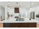 Modern kitchen with stainless steel appliances, white cabinets, and a large center island at 3598 Trinity St, North Port, FL 34291