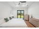 Bright main bedroom with trey ceiling, wood floors, and sliding glass door to backyard at 3598 Trinity St, North Port, FL 34291