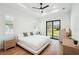 Bright main bedroom with trey ceiling, wood floors, and sliding glass door to backyard at 3598 Trinity St, North Port, FL 34291