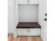 Mudroom features custom bench seating with storage and wood flooring at 3598 Trinity St, North Port, FL 34291