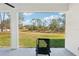 Covered patio boasts serene view of lush backyard and mature trees at 3598 Trinity St, North Port, FL 34291