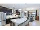 Modern kitchen with dark wood cabinets, stainless steel appliances, and a large center island with seating at 508 Wildlife Gln, Bradenton, FL 34209