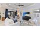 Bright living room with white sofas, a large TV, and plantation shutters for ample light and style at 508 Wildlife Gln, Bradenton, FL 34209