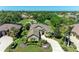 An aerial view of the attractive tan-colored home in a neighborhood with a golf course nearby at 5304 96Th E St, Bradenton, FL 34211