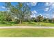 Lush backyard featuring a manicured lawn and a screened pool area at 5304 96Th E St, Bradenton, FL 34211