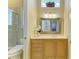 Bathroom with a vanity, decorative mirror, and glass enclosed shower that adds a touch of elegance to the space at 5304 96Th E St, Bradenton, FL 34211