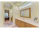 Bright bathroom with a large mirror, double vanity, and an arched entrance at 5304 96Th E St, Bradenton, FL 34211