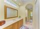 Bright bathroom with a large mirror, double vanity, and an arched entrance at 5304 96Th E St, Bradenton, FL 34211