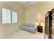 Bright bedroom with a neutral color scheme, a comfortable sofa, and ample natural light from the window at 5304 96Th E St, Bradenton, FL 34211