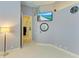Cozy bedroom with blue-gray walls featuring a modern TV, round mirror, and comfortable lighting at 5304 96Th E St, Bradenton, FL 34211