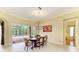 Bright dining room with tile floors, chandelier, and sliding glass doors at 5304 96Th E St, Bradenton, FL 34211