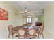 Dining room with oval table, chandelier, and view of the front door at 5304 96Th E St, Bradenton, FL 34211