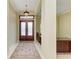 An elegant foyer with tile flooring, a decorative rug, and a decorative chandelier at 5304 96Th E St, Bradenton, FL 34211