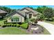 Beautiful single-story home with a well-manicured front yard, lush landscaping, and a long driveway at 5304 96Th E St, Bradenton, FL 34211