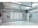 Spacious garage with overhead storage, a window, EV charger, and epoxy floor at 5304 96Th E St, Bradenton, FL 34211