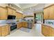 Modern kitchen with stainless steel appliances and tile flooring at 5304 96Th E St, Bradenton, FL 34211