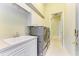 Functional laundry room with modern washer and dryer, sink, and plenty of storage for convenience at 5304 96Th E St, Bradenton, FL 34211