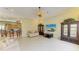 Open living room with tile flooring leads to the kitchen and has an entertainment center at 5304 96Th E St, Bradenton, FL 34211