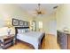 Comfortable main bedroom with wood floors, a ceiling fan, and natural light at 5304 96Th E St, Bradenton, FL 34211