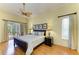 Comfortable main bedroom with wood floors, a ceiling fan, and natural light at 5304 96Th E St, Bradenton, FL 34211