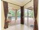 View of the outdoor patio and pool from the interior of the home with decorative drapery at 5304 96Th E St, Bradenton, FL 34211