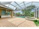 Spacious screened-in pool area with hot tub, outdoor kitchen and tropical landscaping at 5304 96Th E St, Bradenton, FL 34211