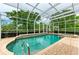 The screened-in pool and spa offer a serene view of lush trees and surrounding landscaping, providing a private oasis at 5304 96Th E St, Bradenton, FL 34211