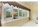 Bright sunroom with tiled floors and lots of windows overlooking the pool and backyard at 5304 96Th E St, Bradenton, FL 34211