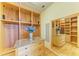 A walk-in closet includes custom shelving, drawers with granite countertop, and a large mirror for dressing at 5304 96Th E St, Bradenton, FL 34211