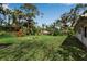 Wide backyard view with lush lawn, mature trees, providing a private outdoor space to relax at 5808 13Th Street E Ct, Bradenton, FL 34203