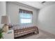 Brightly lit bedroom featuring light walls, a plant on the nightstand, and a twin bed at 5808 13Th Street E Ct, Bradenton, FL 34203