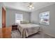 This bedroom includes two windows, a ceiling fan with light, and neutral gray paint at 5808 13Th Street E Ct, Bradenton, FL 34203