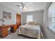 Bright bedroom features a window, soft gray paint, and classic wooden desk at 5808 13Th Street E Ct, Bradenton, FL 34203