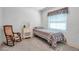 This bedroom offers a rocking chair, a twin bed, and bright natural light at 5808 13Th Street E Ct, Bradenton, FL 34203