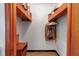 A walk-in closet with wooden shelving and a light blue-painted back wall and parquet wood-patterned flooring at 5808 13Th Street E Ct, Bradenton, FL 34203