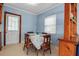 Cozy dining room with bright blue walls and a simple table setting, complemented by natural light at 5808 13Th Street E Ct, Bradenton, FL 34203
