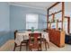 Cozy dining room with bright blue walls and a simple table setting, complemented by natural light at 5808 13Th Street E Ct, Bradenton, FL 34203
