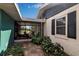 Exterior view of the home featuring a sunroom, white siding, black shutters, and landscaping at 5808 13Th Street E Ct, Bradenton, FL 34203
