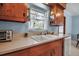 Close-up on kitchen features double basin sink, and natural light from the window at 5808 13Th Street E Ct, Bradenton, FL 34203
