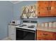 Cozy kitchen features an updated white oven and natural wood cabinets offering ample storage at 5808 13Th Street E Ct, Bradenton, FL 34203