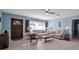 Bright living room with a large window, ceiling fan, and traditional furnishings at 5808 13Th Street E Ct, Bradenton, FL 34203