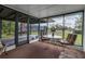 A sunroom with views of the yard, featuring a round table, chairs, and a door to the outside at 5808 13Th Street E Ct, Bradenton, FL 34203