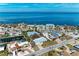 Waterfront home featuring lush landscaping, ocean views, and serene street access at 609 Foxworth Ln, Holmes Beach, FL 34217