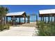 Entrance to the Anna Maria City Pier with covered walkways, leading toward the ocean on a clear, sunny day at 609 Foxworth Ln, Holmes Beach, FL 34217