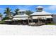 Beachside restaurant with outdoor seating and umbrellas on white sand at 609 Foxworth Ln, Holmes Beach, FL 34217